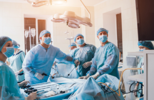 Surgeons look at a monitor while performing surgery