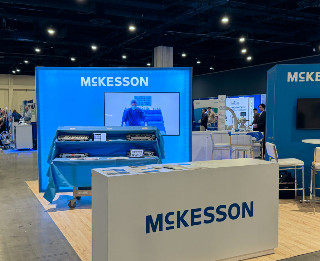 The Mckesson booth at ASCA+SAMBA showcasing DinamicOR's surgical back table, workflow management app, and live action demonstration video.